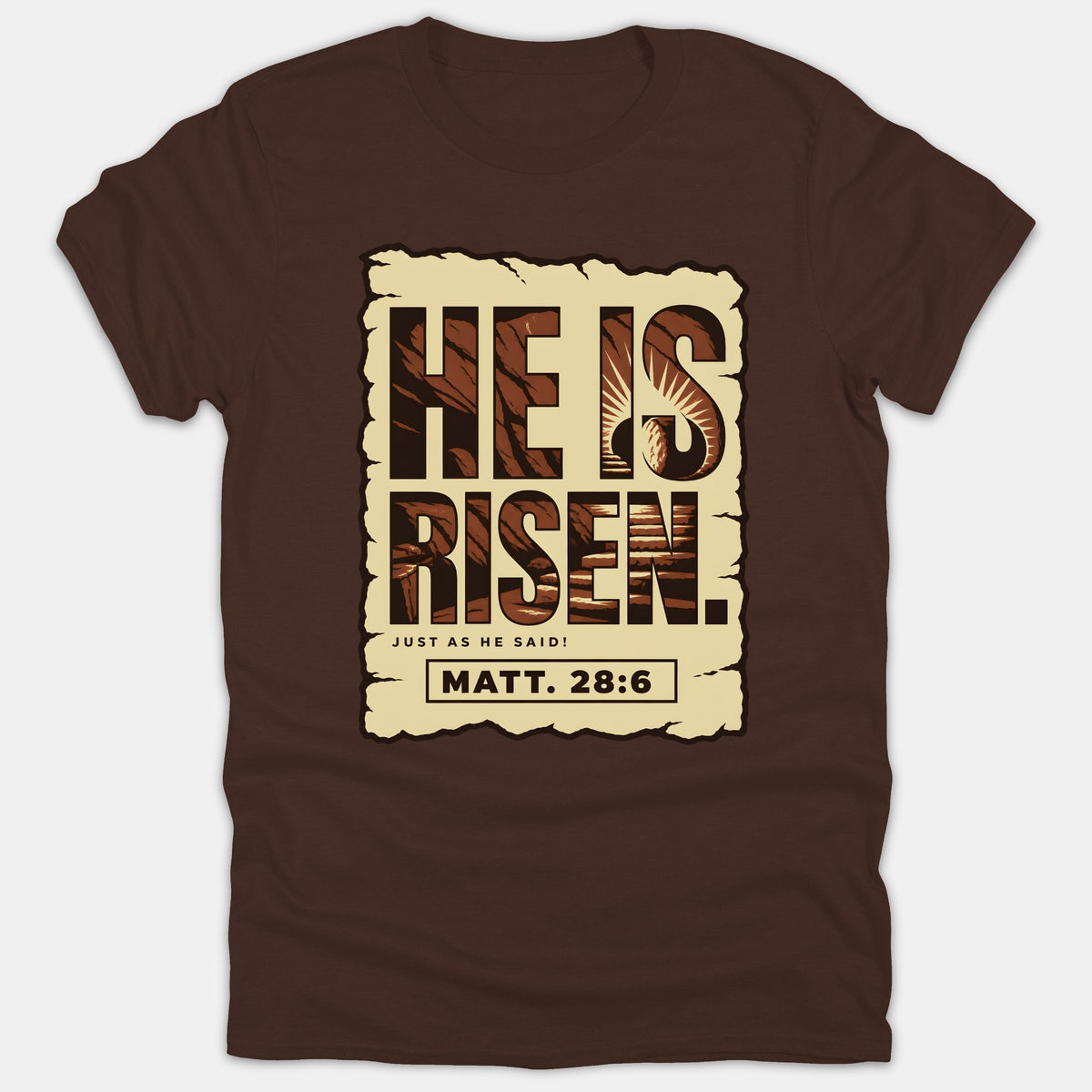 A dark brown Christian t-shirt featuring a graphic print reading 'He Is Risen, Just As He Said! Matt. 28:6' inside a parchment scroll with an empty tomb illustration.