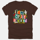 A brown Christian t-shirt featuring a colorful ransom-note style graphic that reads 'I am Spirit anointed' alongside a white dove, cross, and open Bible.