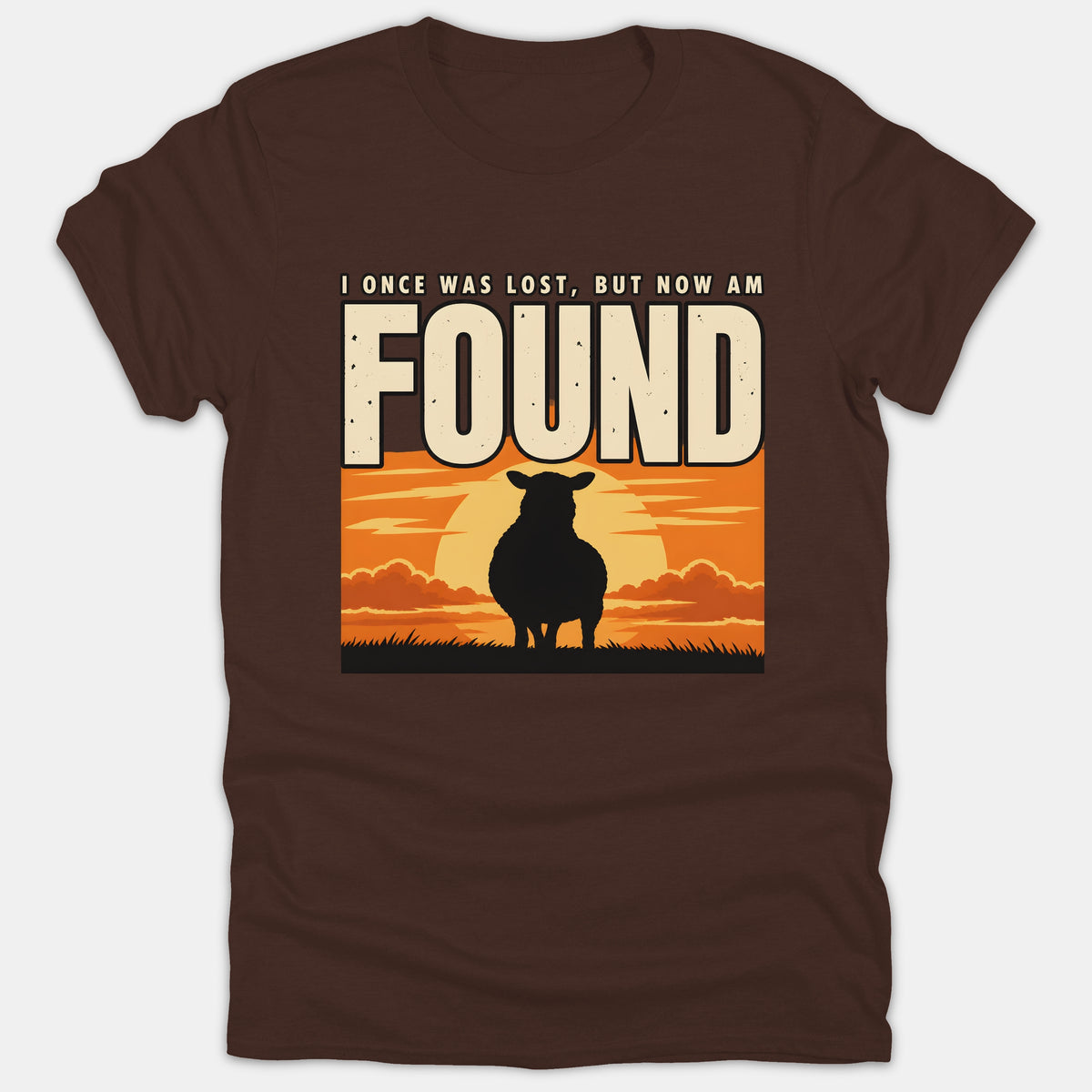 A brown Christian t-shirt featuring the silhouette of a sheep against a vibrant sunset with text that reads, 'I Once Was Lost, But Now Am Found'.