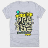 A light gray Christian t-shirt featuring a graffiti-style graphic reading Let Everything That Has Breath Praise The Lord with a Psalm 150:6 scripture reference.