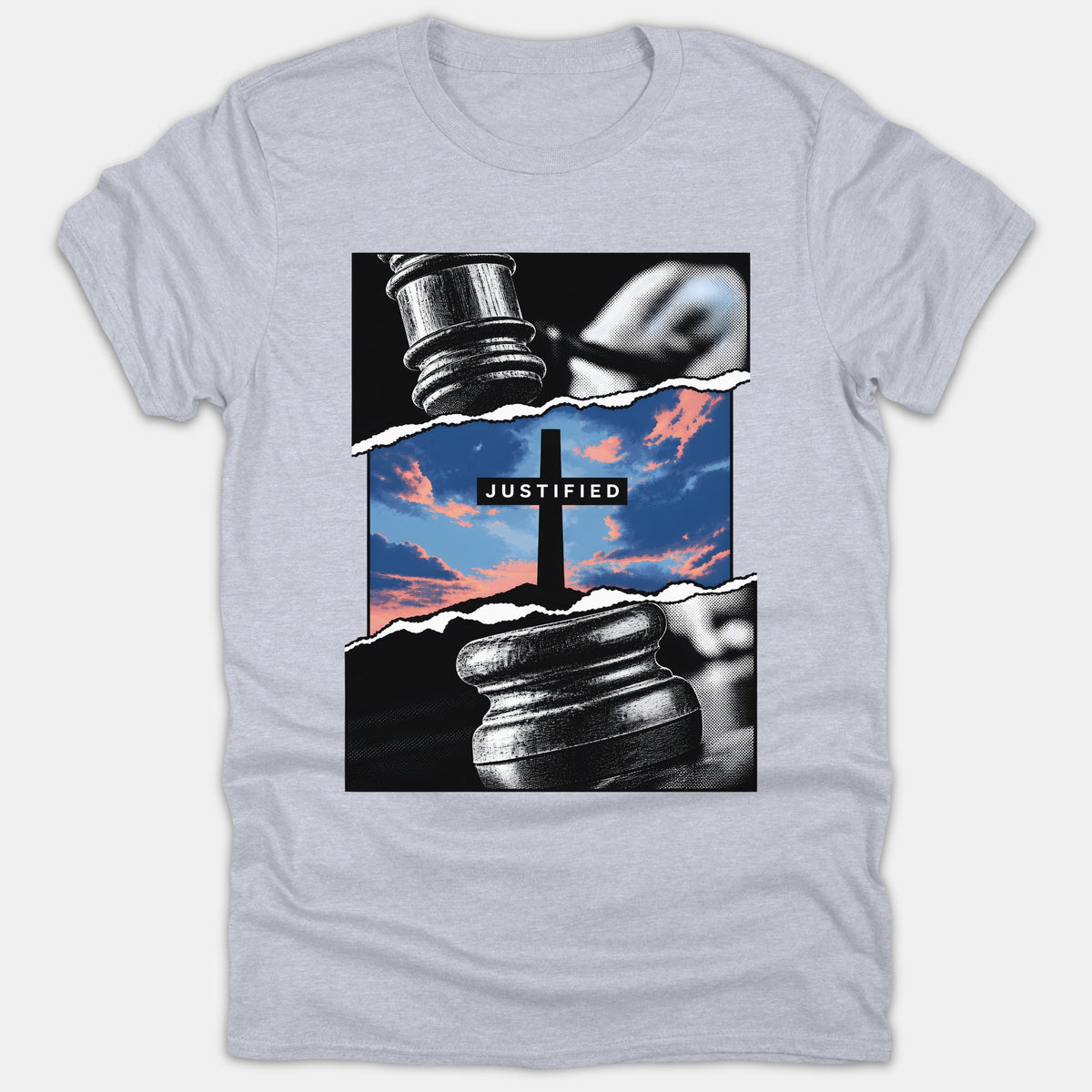 A light gray Christian t-shirt featuring a graphic design of a judge's gavel torn open to reveal a cross against a colorful sunset sky with the word JUSTIFIED.