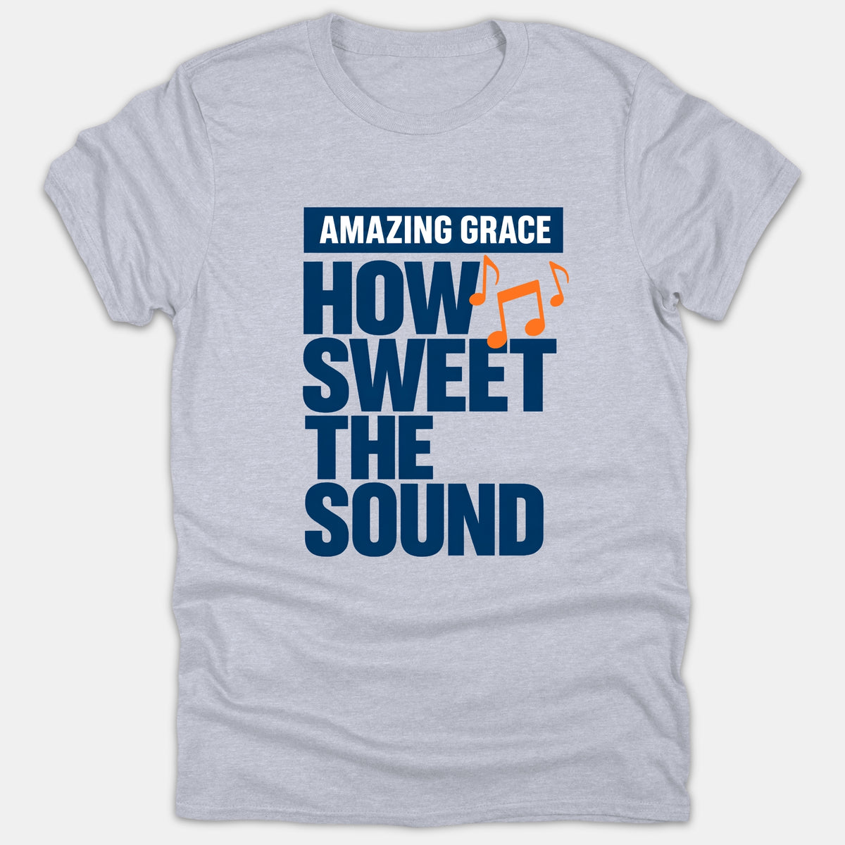 A heather gray Christian t-shirt featuring navy and orange typography that reads 'AMAZING GRACE HOW SWEET THE SOUND' accompanied by musical note graphics.