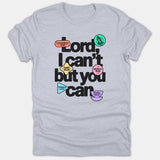 A heather gray Christian t-shirt featuring bold text reading 'Lord, I can't but you can' accented with colorful Bible verse badges.