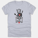 A light gray Christian t-shirt featuring a black distressed handprint with a red wound, above a framed caption reading PAID IN FULL and a red cross.