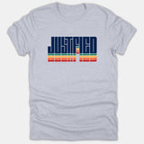 A heather gray t-shirt featuring the word JUSTIFIED in bold navy block lettering above vibrant retro-style horizontal stripes.