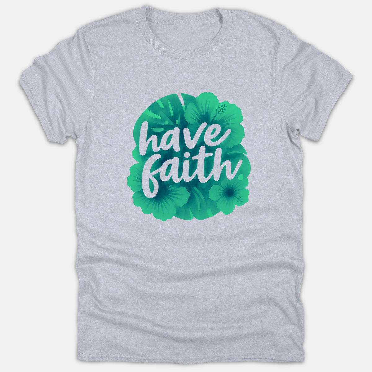 A light gray Christian T-shirt featuring the text 'have faith' in white cursive typography over a green tropical floral illustration.