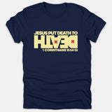 A navy blue t-shirt displaying a light yellow typography graphic that reads 'JESUS PUT DEATH TO DEATH' with red X marks, followed by '1 CORINTHIANS 15:54-55'.
