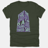 A dark green T-shirt featuring a tower-shaped graphic composed of the scripture verse, 'The name of the Lord is a strong tower,' in teal and purple typography.