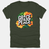 A dark green T-shirt featuring bold 3D white text that reads 'GRACE & PEACE' surrounded by vibrant tropical orange hibiscus flowers and green palm leaves.