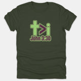A dark green Christian T-shirt featuring a cross, greater-than symbol, and lowercase i graphic above the Bible verse reference John 3:30 printed in lime green and purple.