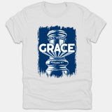 A white Christian T-shirt featuring a distressed navy blue pillar graphic with the text 'God's Verdict: Grace' and scripture reference 'Romans 8:1'.