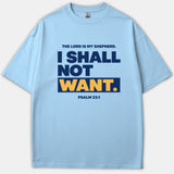 A light blue Christian t-shirt featuring the Scripture quote 'The Lord is my shepherd, I shall not want' from Psalm 23:1 printed in bold navy and yellow typography.