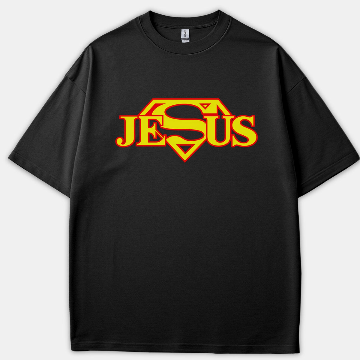 A black Christian t-shirt displaying the name JESUS stylized into a red and yellow superhero shield emblem.