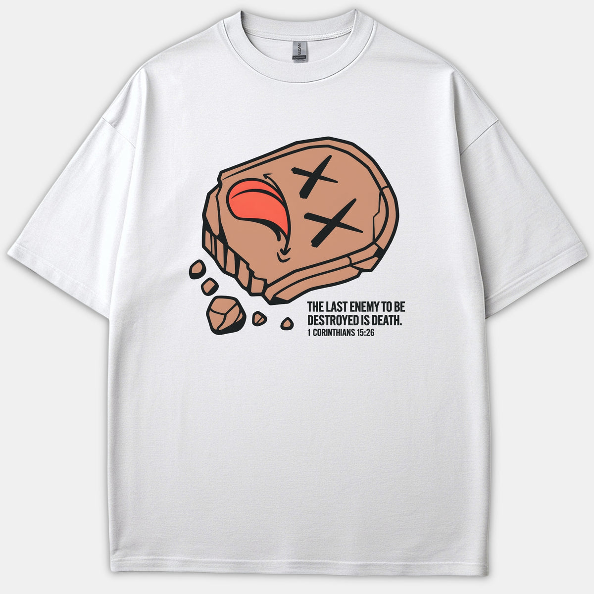 White Christian t-shirt featuring a graphic illustration of a defeated stone face alongside the scripture 1 Corinthians 15:26 reading, The last enemy to be destroyed is death.