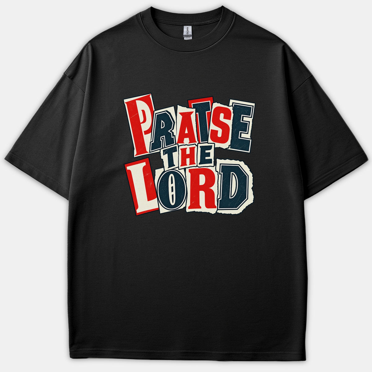 Black t-shirt featuring a bold graphic print that reads Praise The Lord in a vintage cutout collage style using red, navy blue, and white letters.