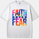 A white Christian t-shirt featuring a vibrant, multicolored brushstroke graphic design that reads FAITH OVER FEAR across the front.