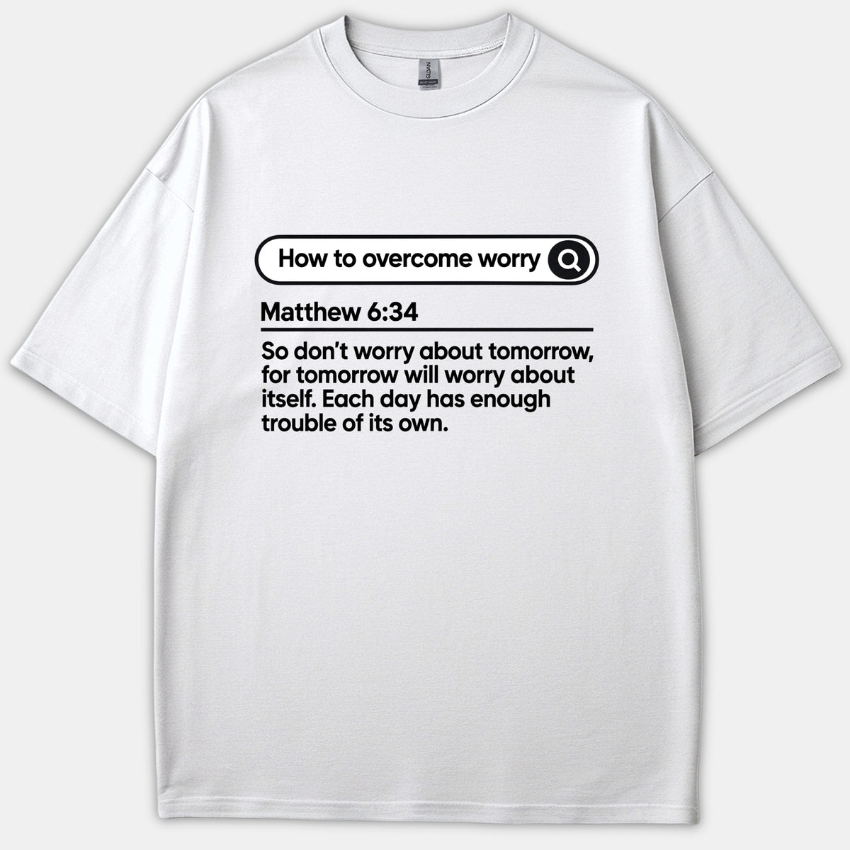 A white Christian T-shirt featuring a search bar graphic reading How to Overcome Worry above the scripture text for Matthew 6:34 in bold black print.