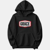 A black hoodie featuring a red and white crest design on the chest with the text GRACE: God's Riches At Christ's Expense.