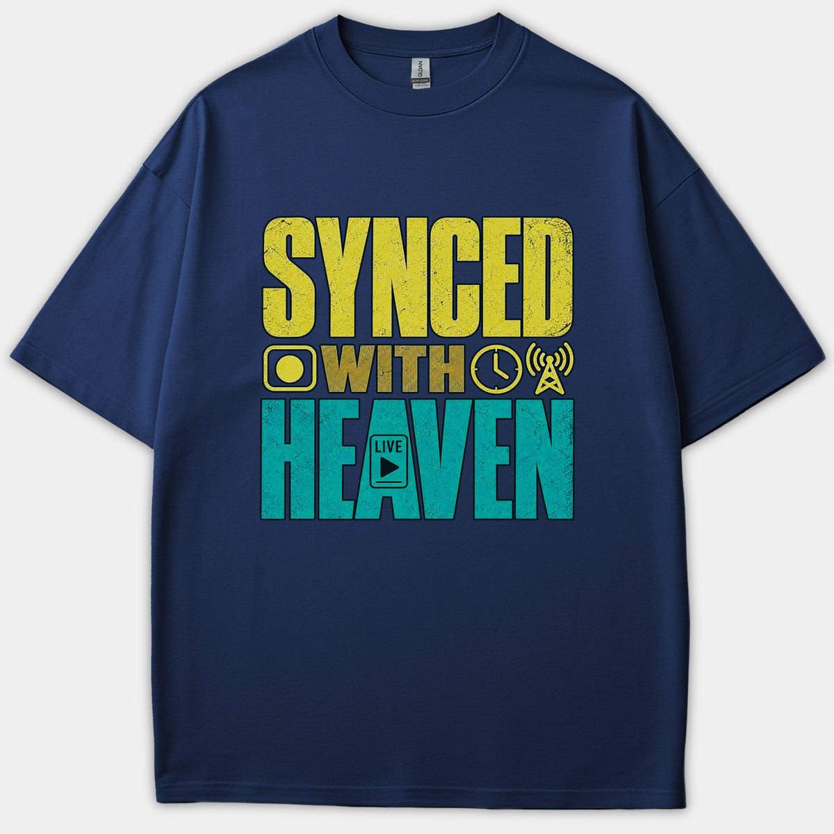 A navy blue Christian t-shirt featuring bold distressed typography that reads 'SYNCED WITH HEAVEN' alongside media icons in yellow and teal.