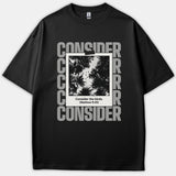 A black T-shirt featuring a polaroid picture of silhouette trees and birds surrounded by the word CONSIDER, with the text Consider the birds. (Matthew 6:26) written at the bottom.