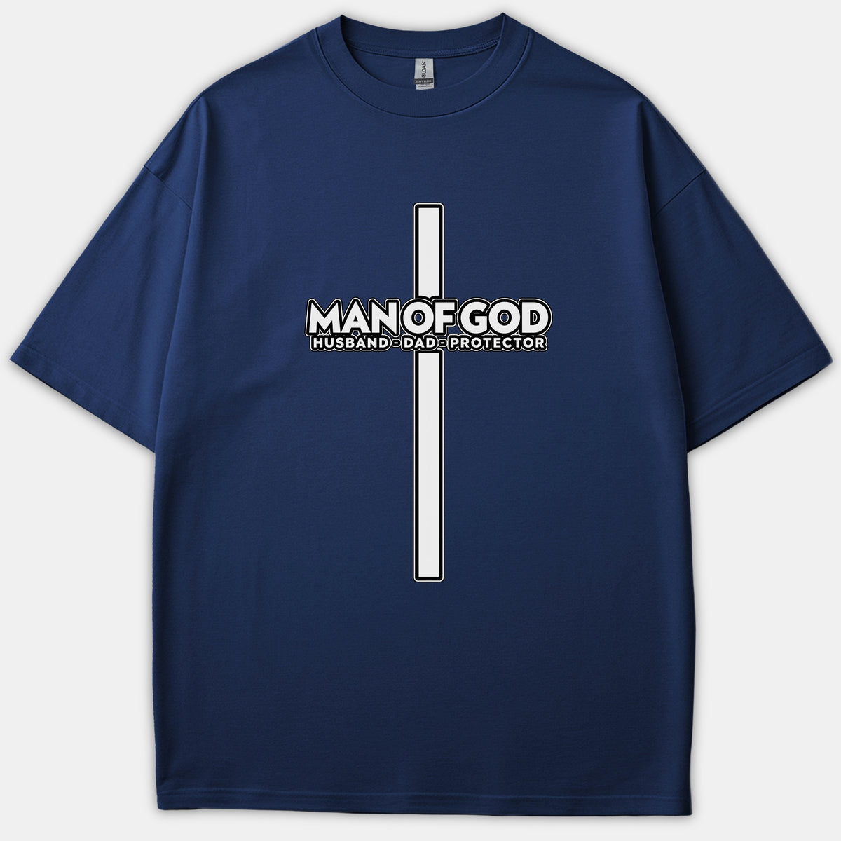 A navy blue t-shirt featuring a tall Christian cross graphic with the words MAN OF GOD HUSBAND DAD PROTECTOR printed in white across the center.
