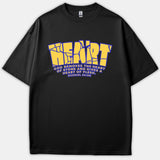 A black T-shirt featuring a cracked yellow typography design reading 'HEART' above the Bible verse Ezekiel 36:26 about God replacing a heart of stone with flesh.
