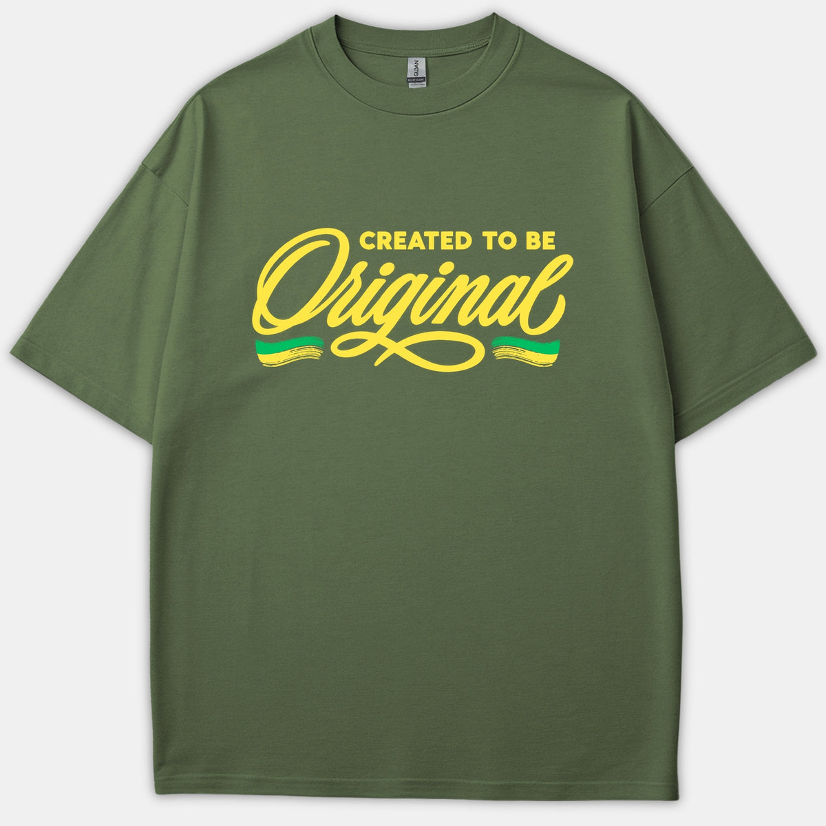 An olive green Christian t-shirt featuring the text 'CREATED TO BE Original' printed in yellow block letters and stylish script with decorative brushstrokes.