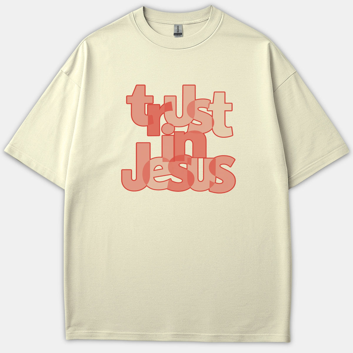 A beige t-shirt featuring overlapping typography that reads 'trust in Jesus' printed in shades of red and pink.