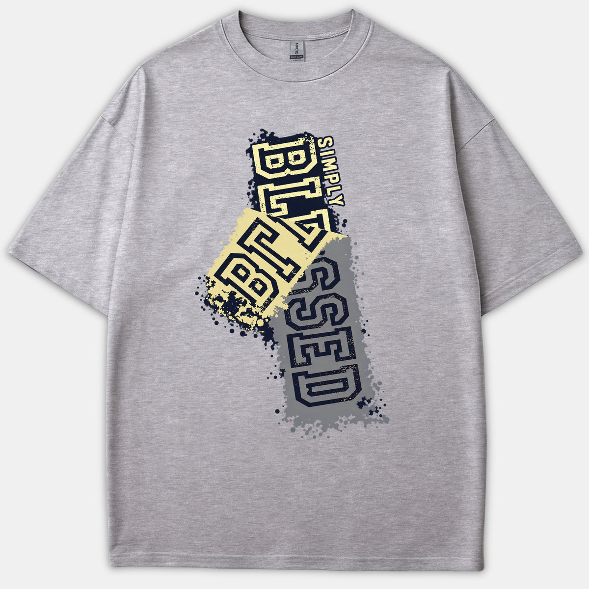 A heather gray t-shirt featuring a grunge-style graphic with paint splatters reading Simply Blessed in bold yellow and navy block lettering.