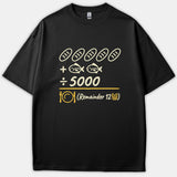 A black T-shirt featuring a Christian math graphic depicting five loaves and two fish divided by 5000 with a remainder of 12 baskets in yellow.