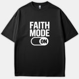 A black t-shirt featuring a white graphic print that reads 'FAITH MODE' above a toggle switch set to 'ON'.