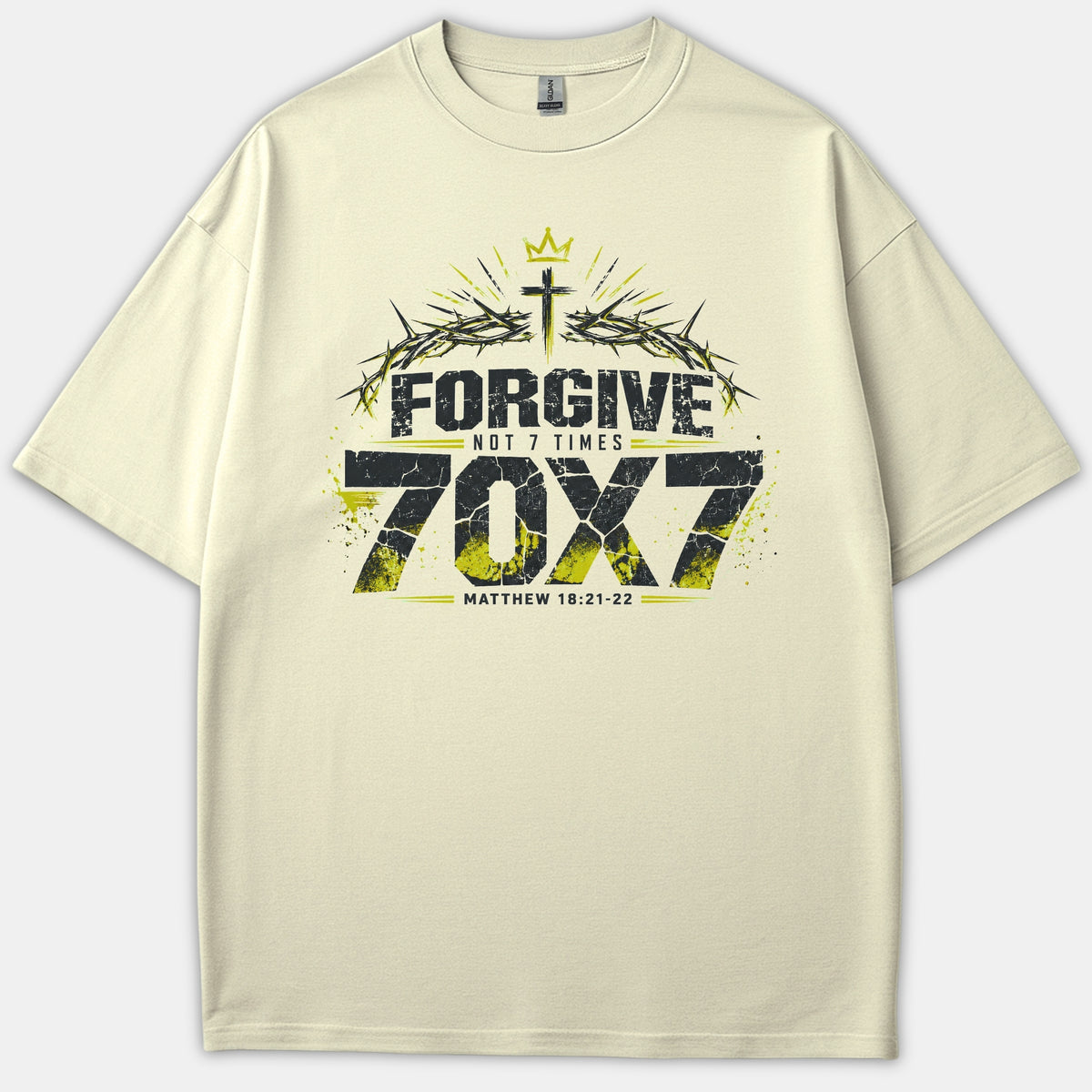 A beige T-shirt featuring a Christian graphic design that reads 'FORGIVE NOT 7 TIMES 70X7' with a cross, crown of thorns, and the scripture reference Matthew 18:21-22.