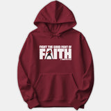 A maroon hoodie featuring a bold graphic reading 'Fight the Good Fight of Faith' with a silhouette of a boxer in red gloves and scripture reference 1 Timothy 6:12.