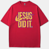 A red Christian t-shirt featuring yellow typography outlined in purple that reads 'JESUS DID IT' styled with a swoosh and a small cross.