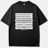A black T-shirt featuring a bold white graphic design with the scripture quote Grow in the grace and knowledge of our Lord Jesus Christ from 2 Peter 3:18.