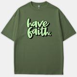 An olive green Christian t-shirt featuring the phrase Have Faith in a light green bubbly script font with a black drop shadow.
