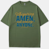 A green Christian t-shirt featuring the phrase 'Whispering AMEN, not waking ANYONE.' printed in blue and yellow typography.