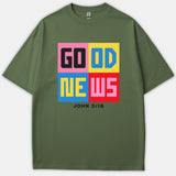 An olive green Christian t-shirt featuring a colorful four-quadrant graphic reading GOOD NEWS with the bible verse reference JOHN 3:16 printed below.