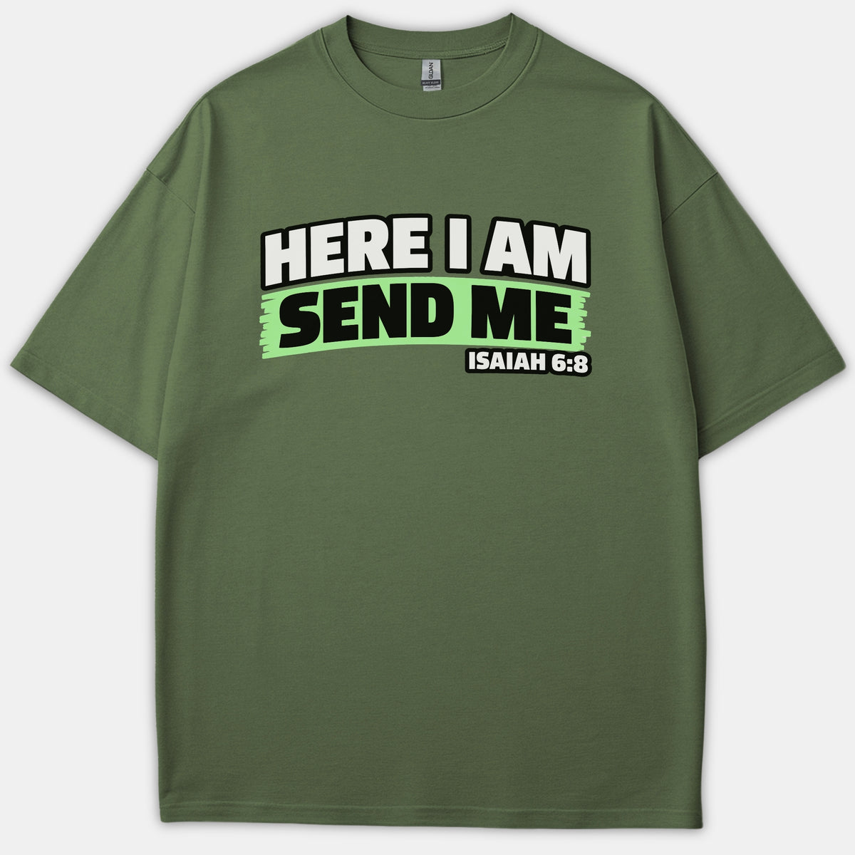 A green Christian t-shirt featuring the scripture phrase HERE I AM SEND ME ISAIAH 6:8 printed across the chest in bold white and black lettering.