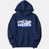 A navy blue hoodie featuring a graphic print that reads 'Jesus Said Love Your Enemies' with 'Matthew 5:44' in bold white text over a blue background block.