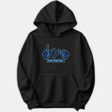 A black hoodie featuring a Christian graphic design with hand gestures framing a greater-than sign above the text GOD OVER SELF in vibrant blue tones.
