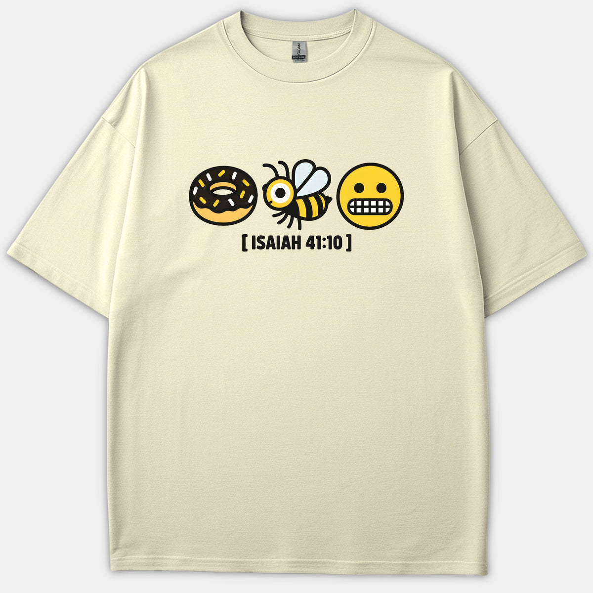 A beige T-shirt featuring a Christian rebus graphic with a donut, a bee, and a scared face emoji above the printed text ISAIAH 41:10.