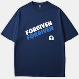 A navy blue Christian t-shirt featuring the word FORGIVEN printed in bold white and blue text alongside a tomb icon with a cross.