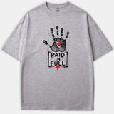 A light gray t-shirt featuring a black handprint graphic with a red mark in the palm above the text 'PAID IN FULL' and a small red cross.