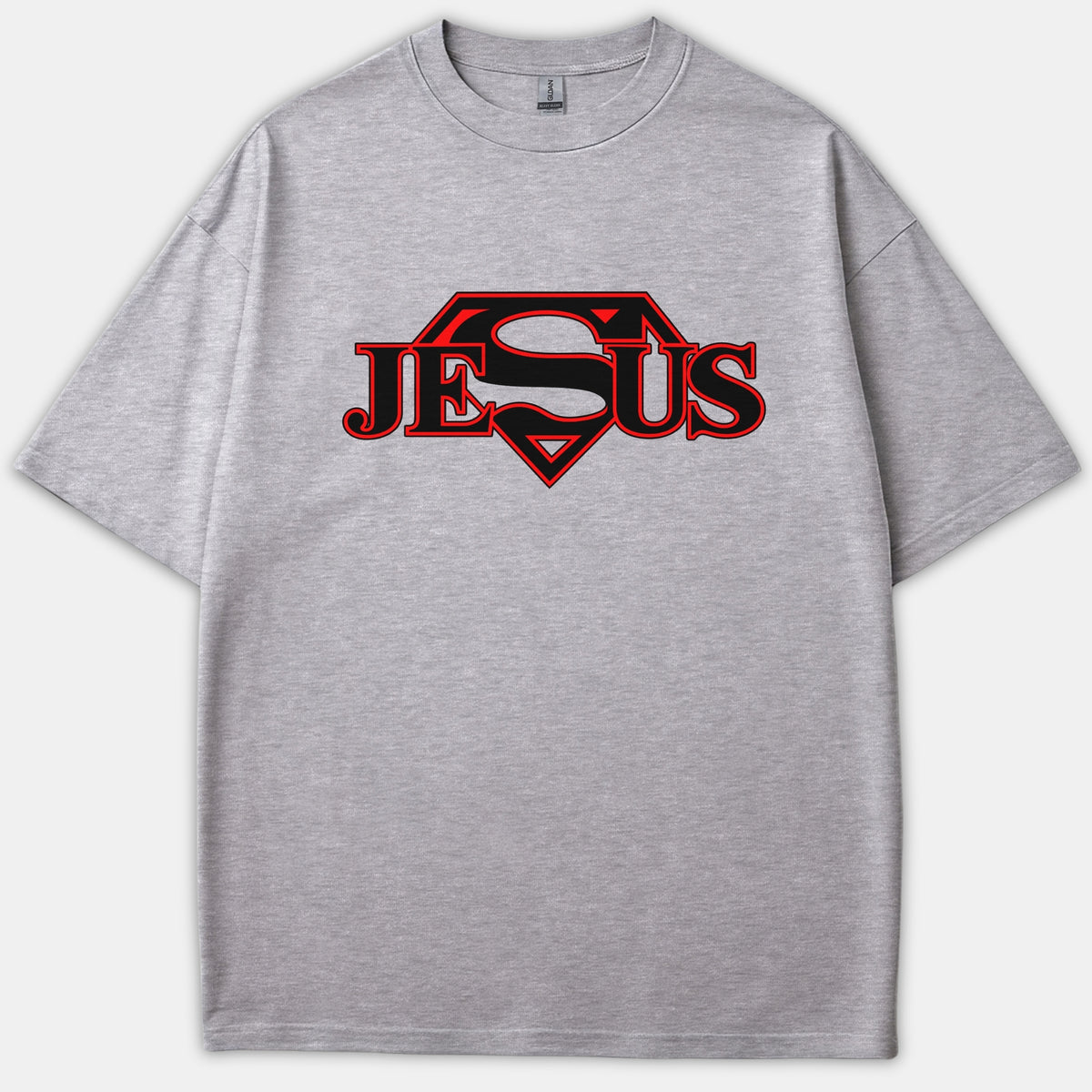 A gray Christian t-shirt featuring the name Jesus in bold red and black lettering, styled with a superhero Superman-inspired diamond emblem.