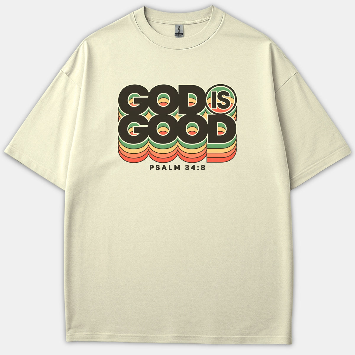 A beige Christian t-shirt featuring retro layered typography that reads 'GOD IS GOOD' with 'PSALM 34:8' printed below in black, green, orange, and yellow hues.