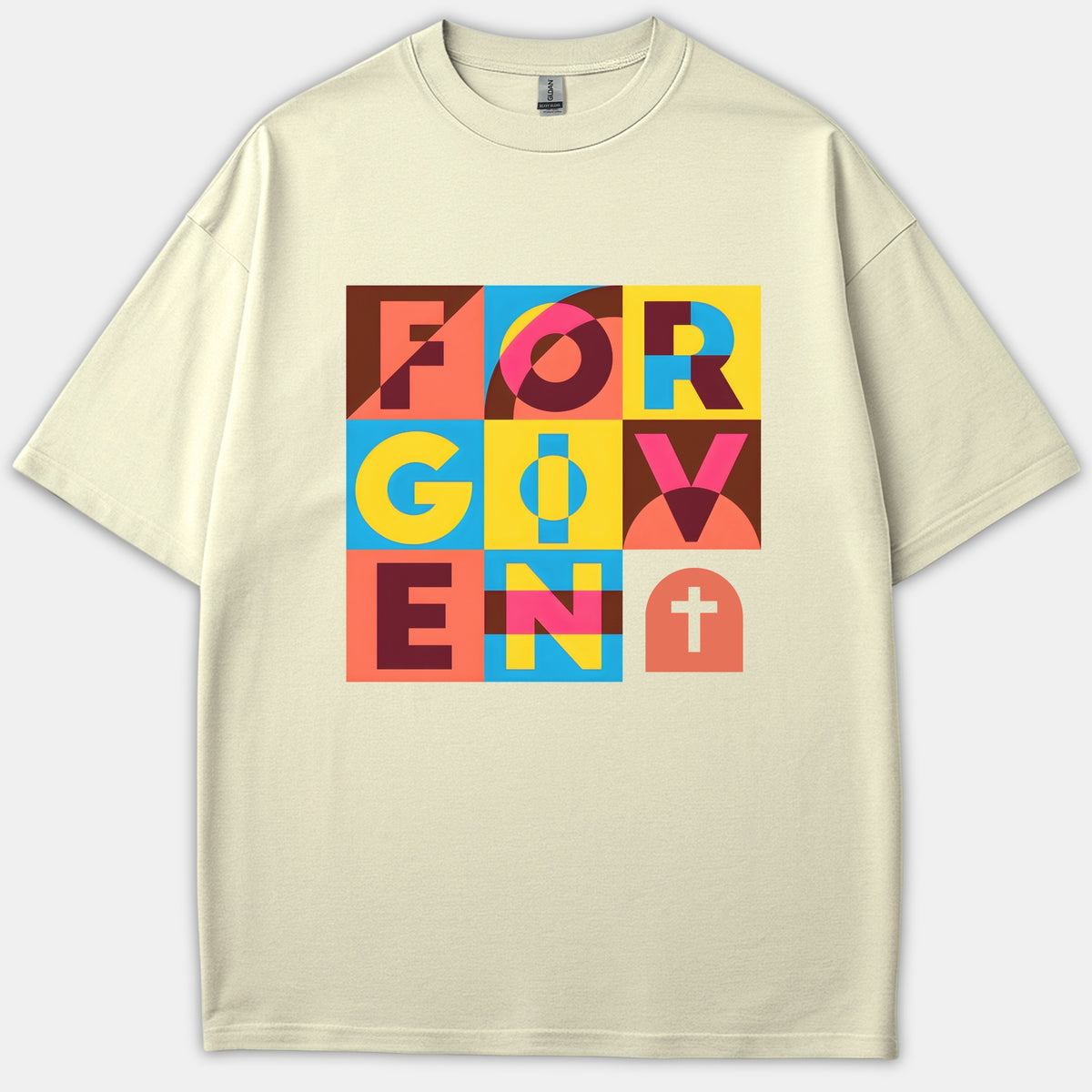A beige Christian t-shirt displaying a colorful geometric block design that spells out FORGIVEN alongside a white cross symbol.