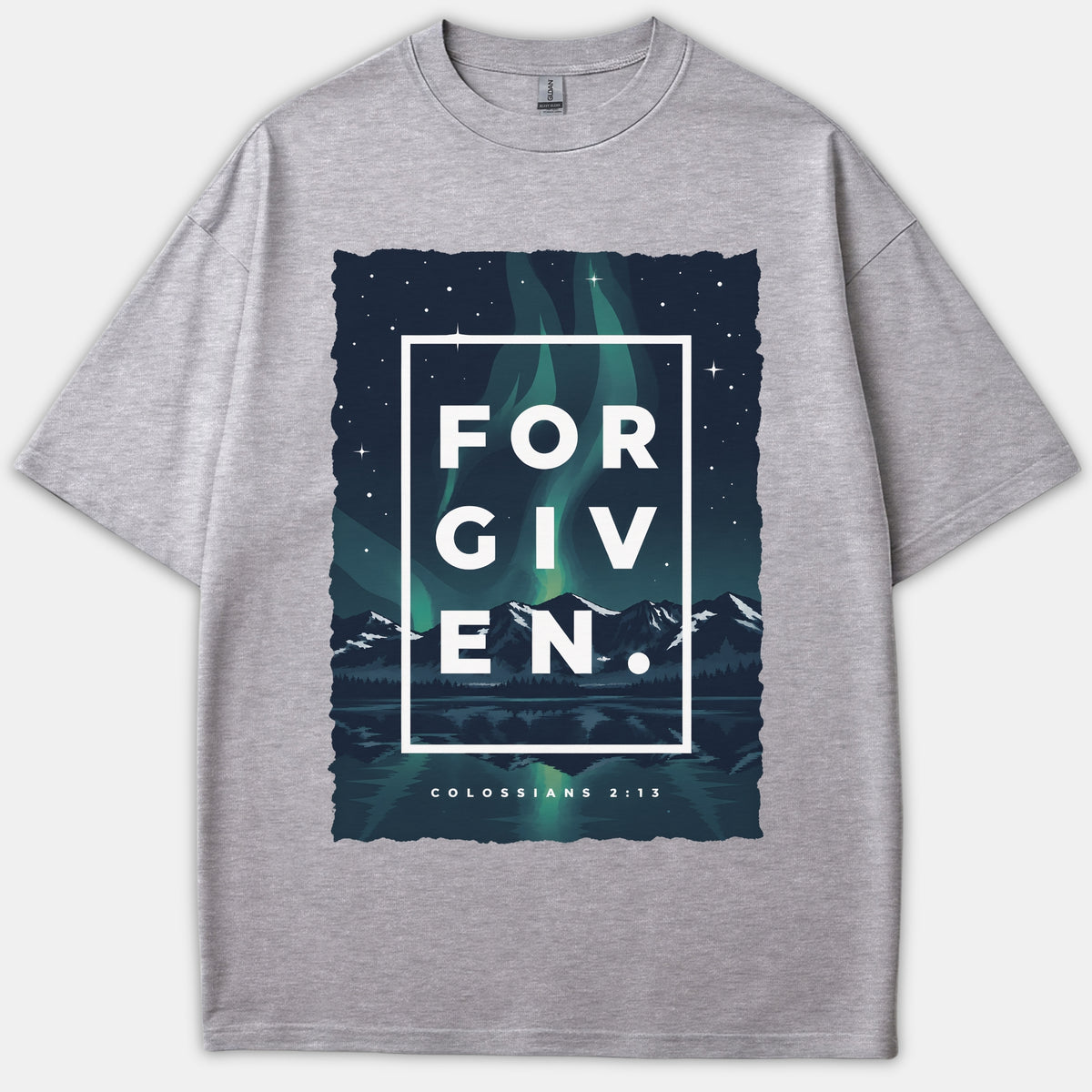 A gray Christian t-shirt featuring a mountain landscape under green northern lights with the word FORGIVEN inside a white box and Colossians 2:13 printed below.
