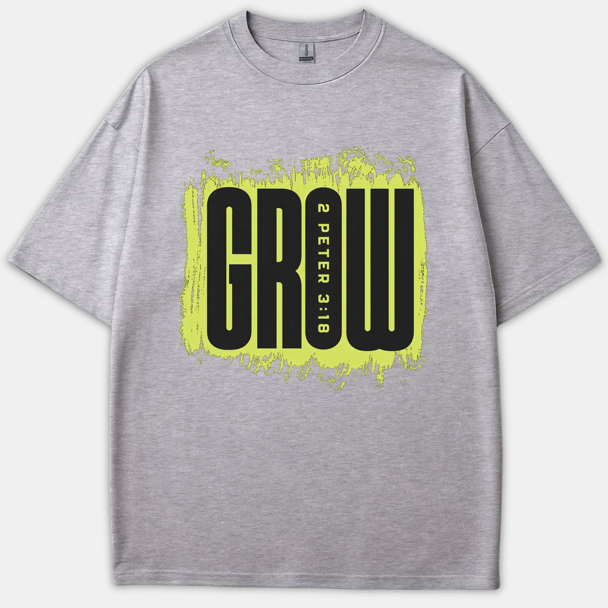 A gray t-shirt featuring a neon yellow distressed background graphic with the word GROW and scripture reference 2 Peter 3:18 printed in bold black.