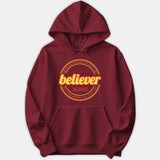A maroon red hoodie featuring a circular yellow and orange graphic that reads Believer In Jesus along with scripture text from John 3:36.